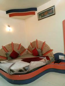 1 dormitorio con 1 cama con almohadas rojas en Hotel Amar palace pachmarhi en Pachmarhī