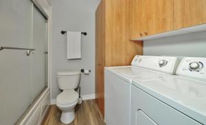 a white bathroom with a toilet and a sink at 16 Chemin Alpin in Stoneham +19 photos