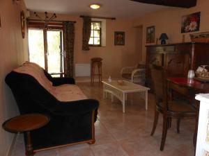 a living room with a couch and a table at Gîte de Châteaurenard in Saint-Léger