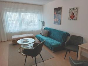 a living room with a couch and a table and chairs at Apartment-Ferienwohnung in Mainaschaff in Mainaschaff