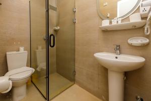 a bathroom with a toilet and a sink and a shower at Giza Pyramids View Inn in Cairo