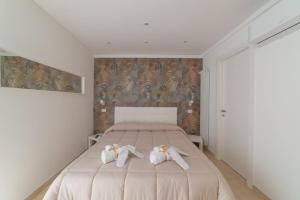 a bedroom with a bed with two towels on it at Stone House Michelle in Torre Annunziata