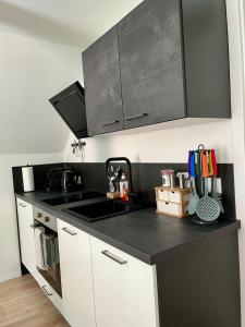 a kitchen with a black and white counter top at Flores City Center Studio - Easy Self-Check-IN in Graz