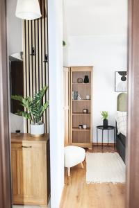 a living room with a chair and a table at Apartament Kokpit in Piła