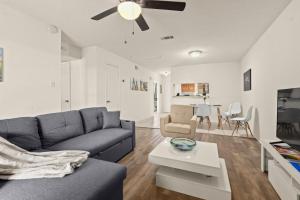 a living room with a couch and a table at LSU 2Bed/2Bath Angel Studios Condo *NEW* in Baton Rouge