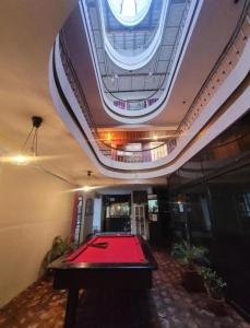 a room with a pool table in a building at Puruha Inn in Riobamba
