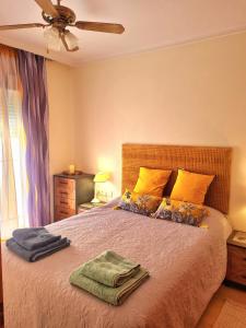 a bedroom with a bed with two towels on it at Casa en Punta Prima in Alicante