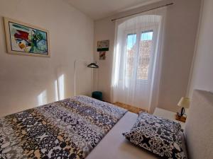 a bedroom with a bed and a window at Downtown Apartment Nora in Split