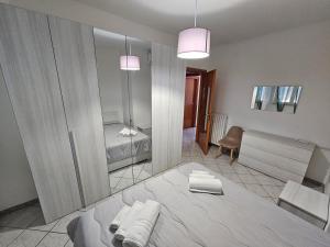 ein Schlafzimmer mit einem großen Bett und einem Spiegel in der Unterkunft Ariosto House in Porto Cesareo