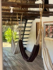 a room with two hammocks hanging from the ceiling at Coco Beach in El Paredón Buena Vista