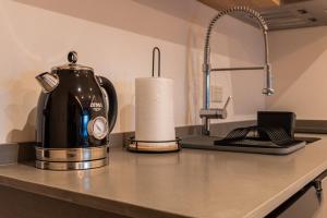 a coffee maker sitting on a counter in a kitchen at Lake Inn - Departamentos con costa de Lago in San Carlos de Bariloche