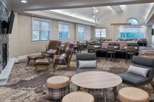 a waiting room with tables and chairs at Residence Inn Wayne in Wayne