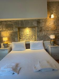 a bedroom with a bed with two towels on it at MaSaLa Otel in Alacati
