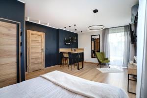 Apartamenty i Pokoje Złote Piaski في ياستراوبيا جورا: غرفة نوم بسرير ومطبخ مع طاولة
