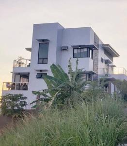 a large white house on top of a hill at SpittlerVilla in Talisay