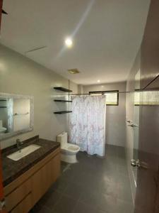 a bathroom with a sink and a toilet and a shower at SpittlerVilla in Talisay