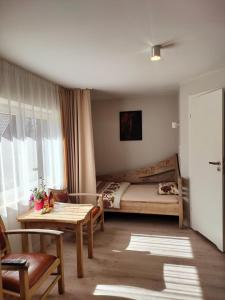 a bedroom with a bed and a table and a table sidx sidx sidx at Pod Berdem in Wetlina