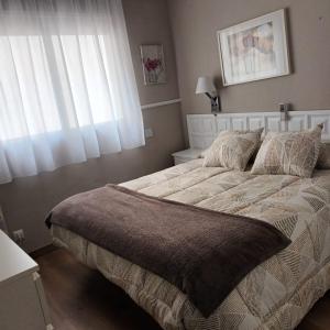 une chambre avec un grand lit avec une fenêtre dans l'établissement Primera Linea De Mar En Cambrils, à Cambrils