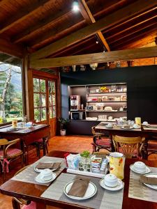 a dining room with tables and chairs in a building at La Casina de la Arquera in Llanes