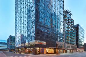 a tall building with many windows in a city at Residence Inn by Marriott Toronto Downtown / Entertainment District in Toronto