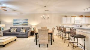 a living room with a couch and a table and chairs at 612 Willow Bend Condo in North Myrtle Beach