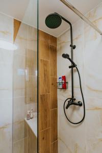 a shower with a glass door in a bathroom at Ariel Pilismarót Vendégház in Pilismarót