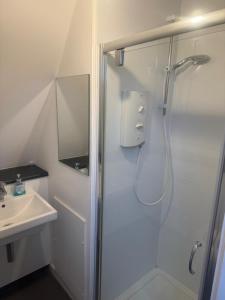 a bathroom with a shower and a sink at Stay Inn East West in Aberdeen