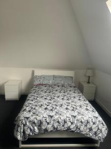 a bedroom with a bed and two night stands at Stay Inn East West in Aberdeen