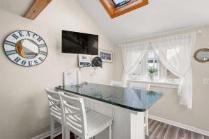 a kitchen with a bar with two white chairs at 131 #7 North Shore Boulevard East Sandwich - Waters Edge 7 in East Sandwich