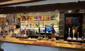 a bar in a pub with a counter top at The Half Moon Inn Rushall IP21 4QD in Pulham Saint Mary the Virgin