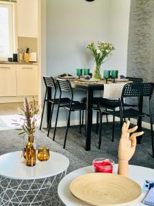 a dining room with a black table and chairs at Glasgow Modern style home , separate entrance in Knightswood