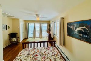 a bedroom with a bed and a painting on the wall at Tally-Sun on the Bluff in Harbor Springs