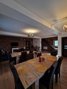 a dining room with a wooden table and chairs at Cabana din Pădure in Porumbacu de Sus