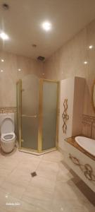 a bathroom with a shower and a toilet and a sink at Vip Apartment Azure Tower in Baku