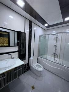a bathroom with a toilet and a shower and a sink at Vip Apartment Azure Tower in Baku