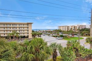 a view of a street with palm trees and buildings at Villa Tuscana in Destin