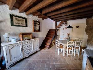 a kitchen with a table and a dining room at Maison Galiléo in Ria +11 photos