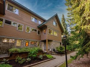 a large house with a stone facade at Modern Home in an Amazing Location by Harmony Whistler in Whistler