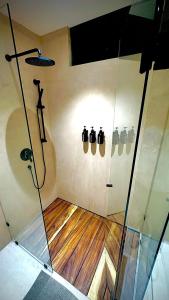 a bathroom with a shower with a glass door at Hotel Boutique Miranda in Oaxaca City