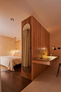 a bedroom with a bed and a large mirror at Hotel Boutique Miranda in Oaxaca City