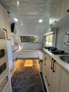 an interior view of an rv kitchen with a sink at LAKOS KARAVAN - SARIGERME BEACH in Dalaman