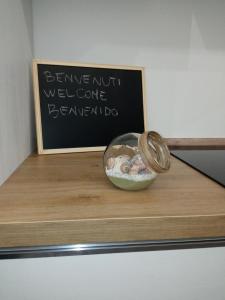 a bowl of food sitting on a shelf with a sign at Voyager in Cagliari