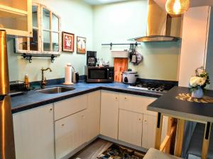 a kitchen with a sink and a stove at Explore New York from Queens in Queens