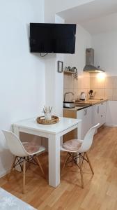 a kitchen with a white table and two chairs at Apartment Mana in Mostar