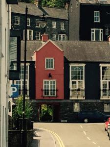 a red building on the side of a street at Heart of Kinsale in Kinsale