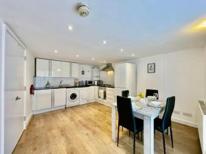 eine Küche und ein Esszimmer mit einem Tisch und Stühlen in der Unterkunft Modern Cosy 1 Bed Ilford Home - Free Parking in Ilford