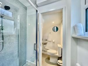 a bathroom with a toilet and a glass shower at Modern Cosy 1 Bed Ilford Home - Free Parking in Ilford