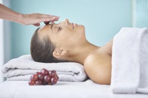 a woman laying on a towel getting a massage at The Yeatman in Vila Nova de Gaia