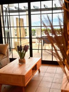 a coffee table in a living room with a large window at Anna in L'Escala