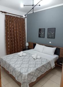 a bedroom with a large bed with white sheets at Vaikouzis Houses in Samothraki